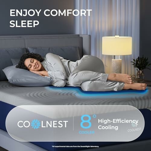A person sleeping comfortably on a cooling mattress topper with a lamp on the bedside table.
