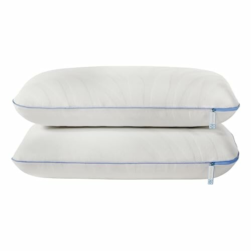 Two stacked white pillows with blue trim.
