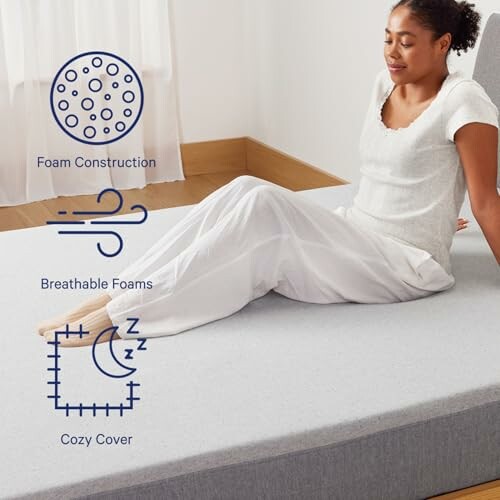 Woman sitting on a mattress with features listed: foam construction, breathable foams, cozy cover.